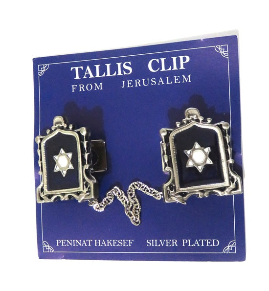 Pair of silver-plated tallit clips with blue enamel inlay and white Star of David design, connected by a chain, displayed on a dark blue card with 'Tallit Clip from Jerusalem