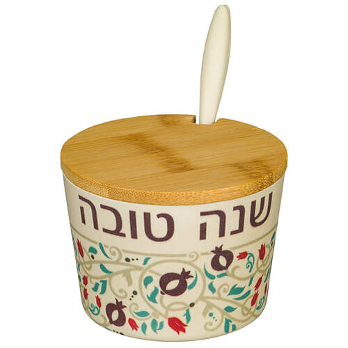 Natural bamboo honey dish engraved with Shana Tovah in Hebrew for Rosh Hashanah.