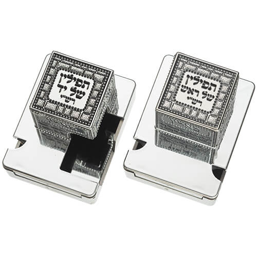 Pair of silver color tefillin boxes with metal plates and Hebrew inscriptions for Shel Rosh and Shel Yad